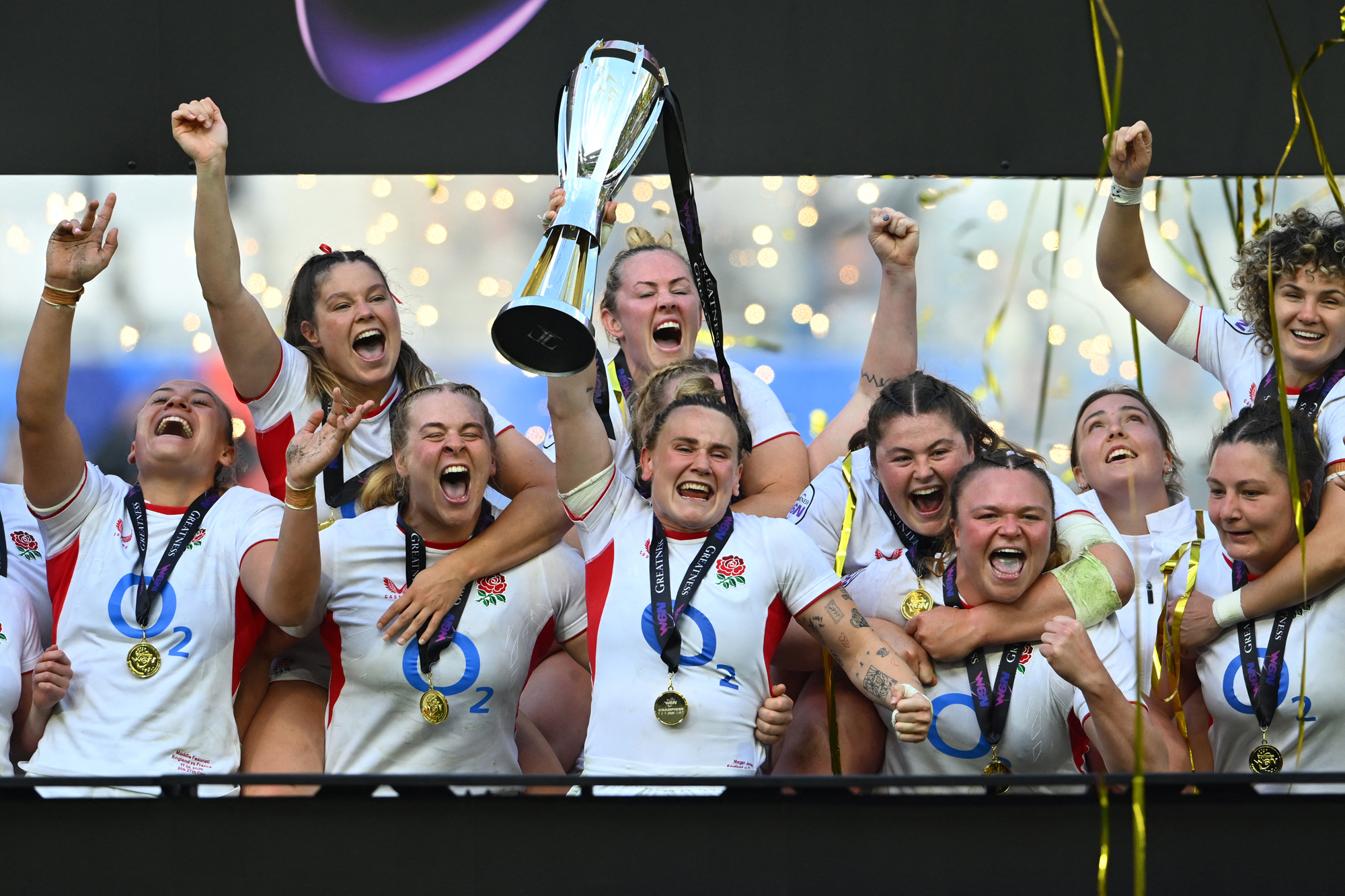 England's Meg Jones lifts the Women’s Six Nations trophy with her teammates in Bordeaux in 2026